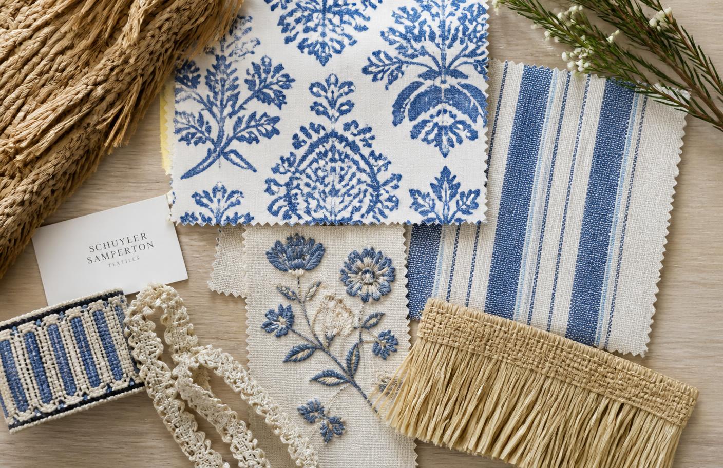 Blue and white block print, stripe, and embroidered fabric samples with raffia trim